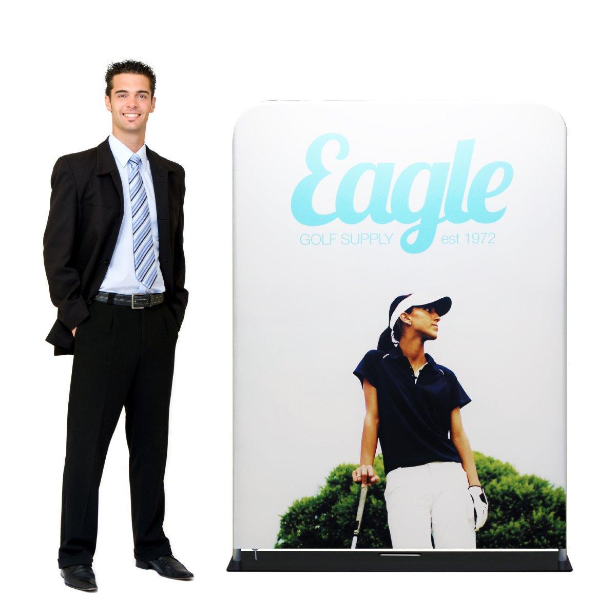 Male model standing next to large fabric trade show display featuring golf supply branding and golfer image