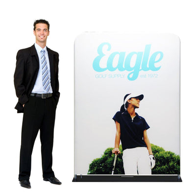 Male model standing next to large fabric trade show display featuring golf supply branding and golfer image