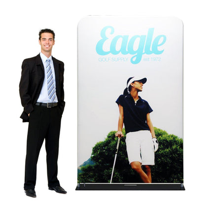 Trade show fabric display featuring golf apparel branding with man in business suit standing beside it