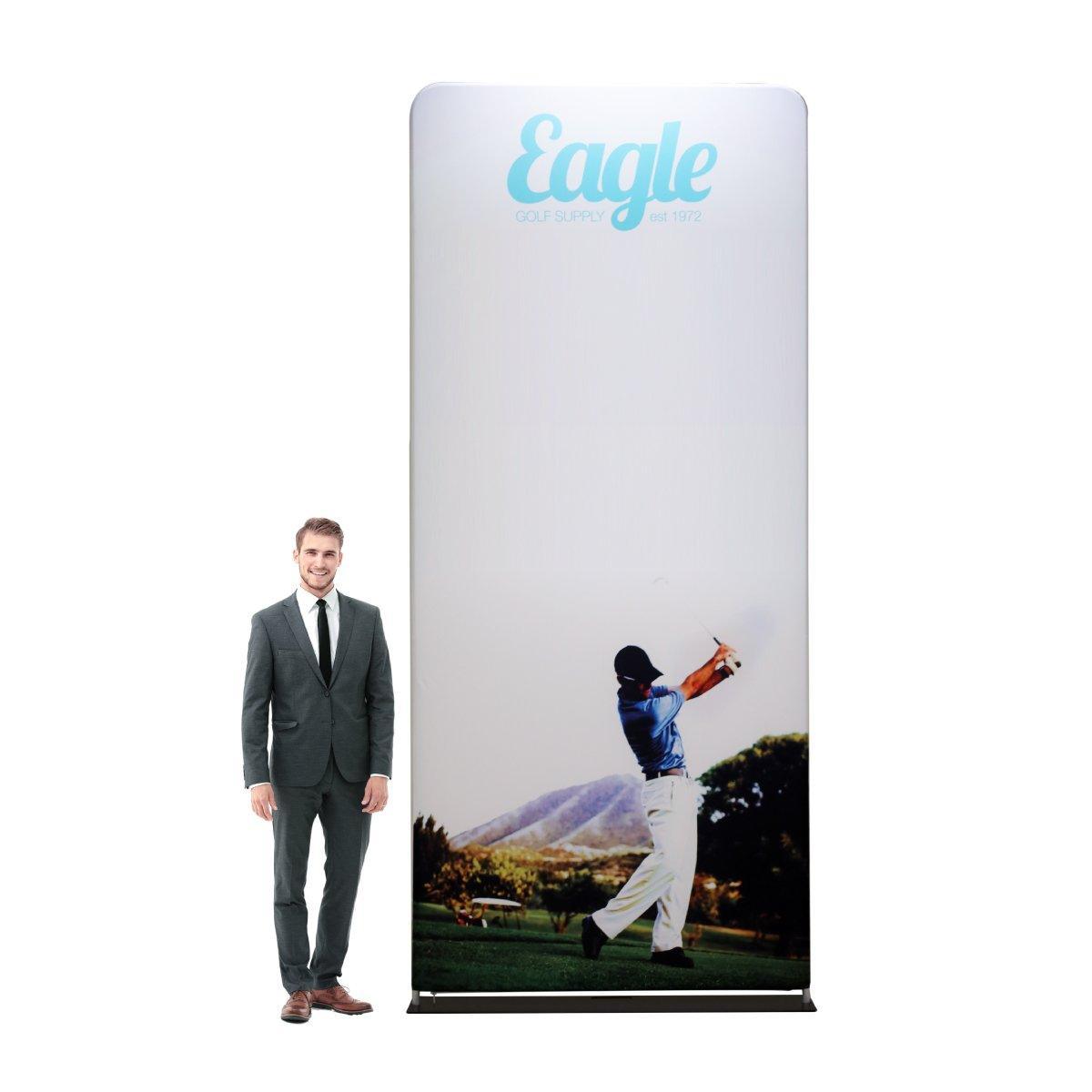 Tall fabric trade show display with golf-themed graphics and branding beside a man in business suit