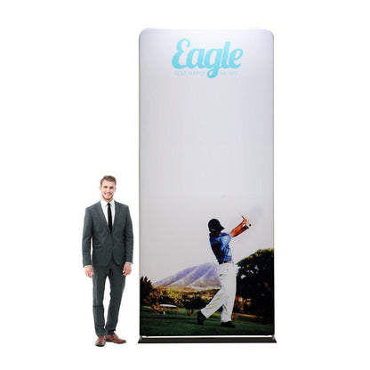 Tall fabric trade show display with golf-themed graphics and branding beside a man in business suit