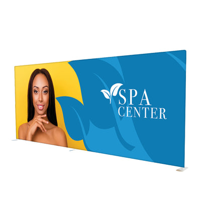 Large trade show display backdrop featuring a spa center ad with a woman and logo, ideal for exhibitions