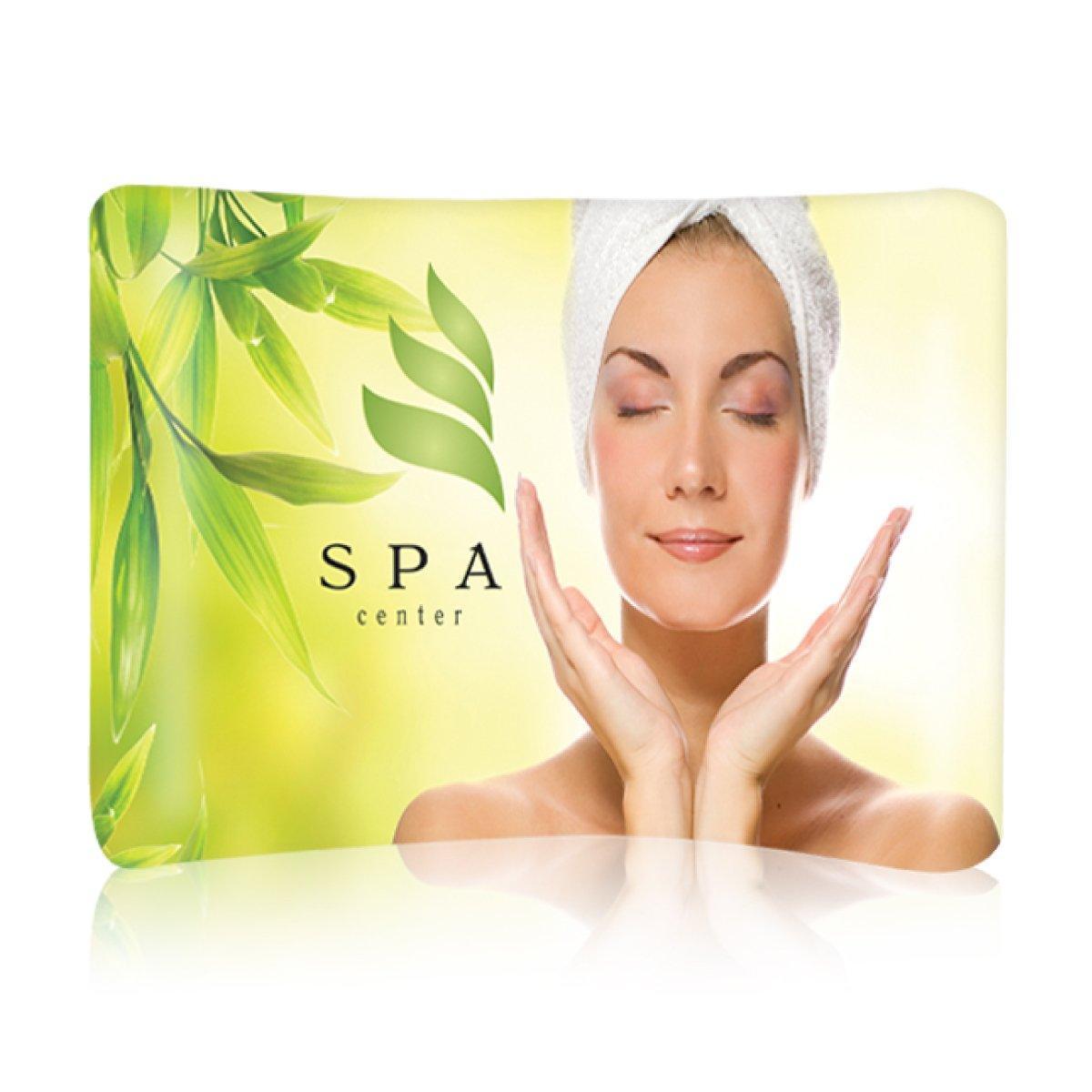 Curved fabric trade show display featuring spa center promotion with relaxing woman and natural leaves