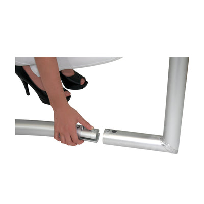 Person assembling trade show frame with metal tube connectors for exhibition display setup