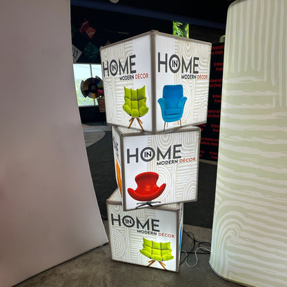 Stacked illuminated display cubes featuring modern décor chair designs for trade shows and exhibitions