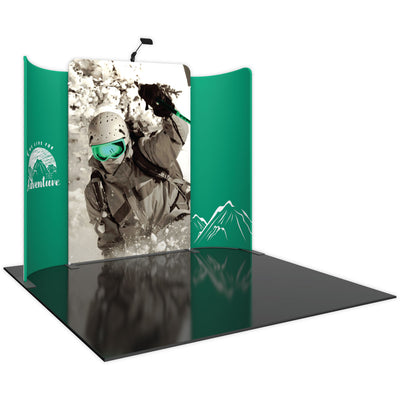 Trade show display with large skier graphic and curved side panels featuring mountain adventure branding