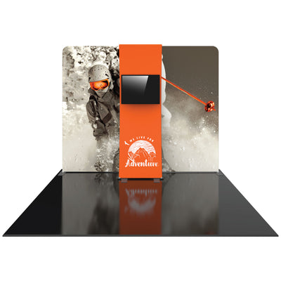 Trade show display featuring large adventure-themed backdrop with action skier and central monitor for exhibitions and events