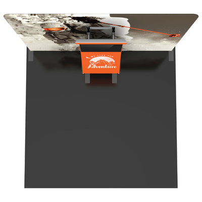 Trade show display with large adventure-themed backdrop and branded counter for exhibitions