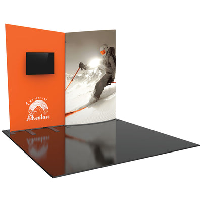 Trade show display booth with large graphic of skier and wall-mounted monitor for exhibitions
