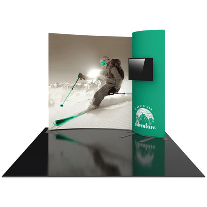 Trade show display featuring large curved graphic of skier on mountain and monitor for exhibitions