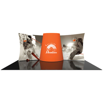 Trade show display with large curved fabric backdrops featuring skiing graphics and a central branding tower for special events