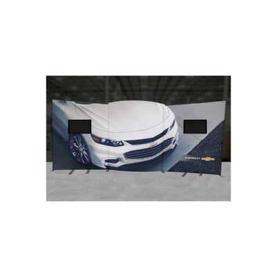 Trade show display featuring curved backlit fabric wall with car image and integrated monitor mounts