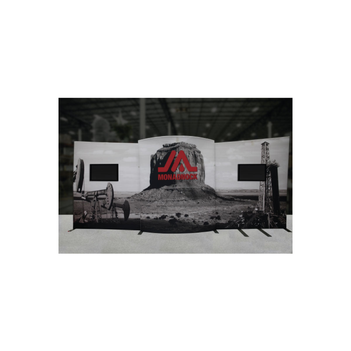 Trade show display backdrop featuring industrial landscape graphics with dual monitor mounts for exhibitions