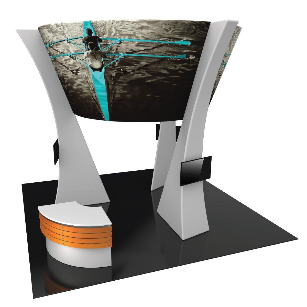 Modern trade show island kit with large curved graphic display, dual monitor stands, and reception counter