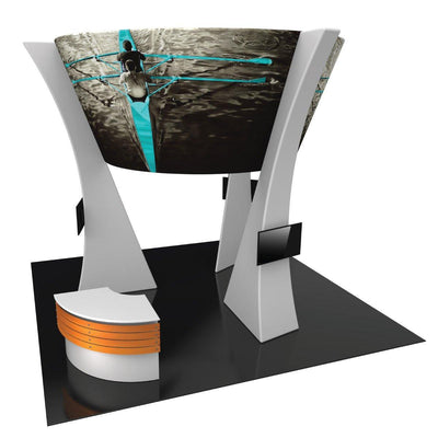 Modern trade show island kit with large curved graphic display, dual monitor stands, and reception counter