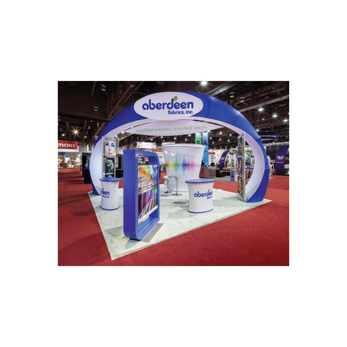 Trade show island booth with curved arch and branded counters for exhibition display