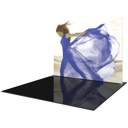 Trade show display featuring large fabric graphic of woman in flowing dress on glossy floor panel for exhibitions