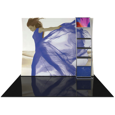 Trade show display with large vertical curved fabric backdrop featuring a flowing dress image and integrated shelving for event marketing