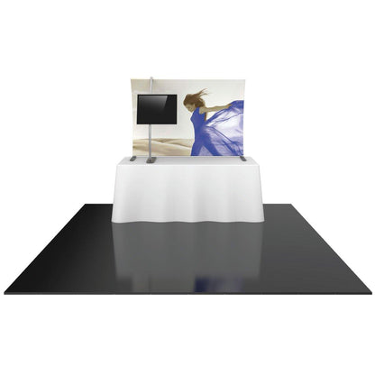 Trade show tabletop display with fabric backdrop featuring a woman graphic and mounted monitor stand