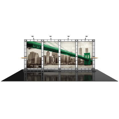 Trade show display frame showcasing multi-panel cityscape graphic with overhead lights and side shelves