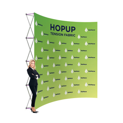 Trade show tension fabric backdrop display with branding, showcased by businesswoman at exhibition