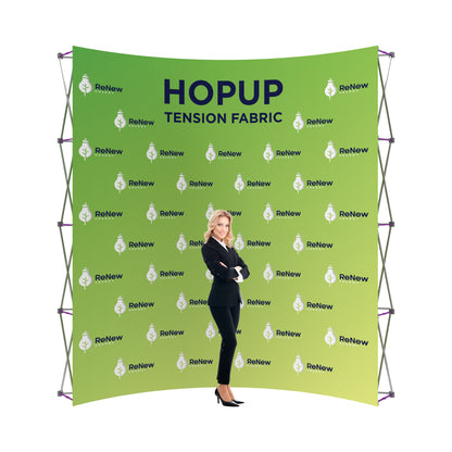 Tension fabric trade show backdrop with ReNew Energy branding and businesswoman standing in front