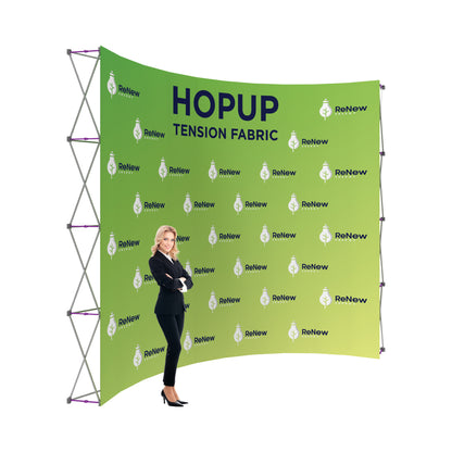 Trade show tension fabric backdrop with ReNew Energy branding and a businesswoman standing beside it