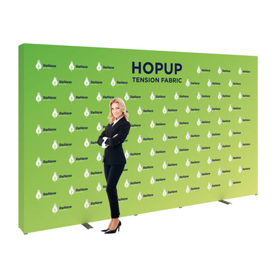 Trade show tension fabric backdrop with branded printing and businesswoman posing in front