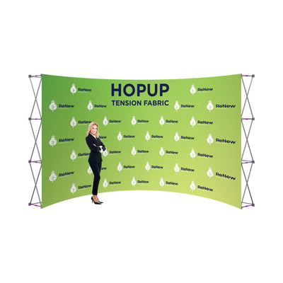 Trade show tension fabric backdrop with custom ReNew Energy branding and a professional woman standing nearby