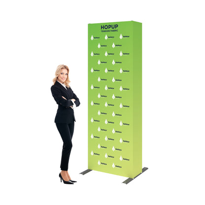 Tall tension fabric trade show display with logo design beside smiling professional woman in suit