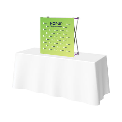 Tension fabric pop-up banner display on table, ideal for trade shows and special events