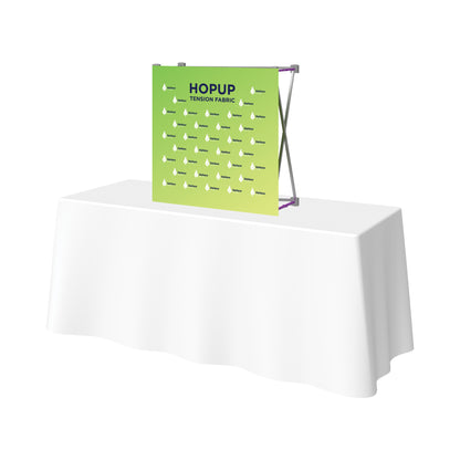 Tension fabric pop-up banner display on table, ideal for trade shows and special events
