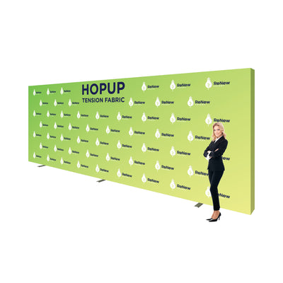 Large hopup tension fabric backdrop with branded graphics standing next to businesswoman at trade shows
