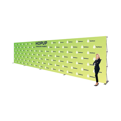Large tension fabric backdrop display with branding for trade shows and exhibitions, woman standing beside it