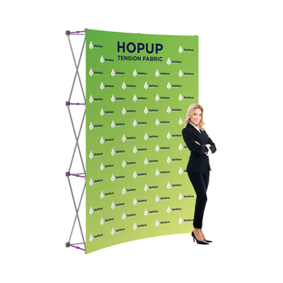 Trade show tension fabric display stand with promotional branding and businesswoman posing