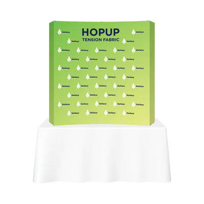 HopUp tension fabric trade show display with branded graphics on tabletop exhibit