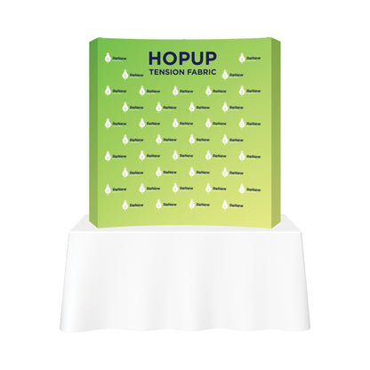 HopUp tension fabric trade show display with branded graphics on tabletop exhibit
