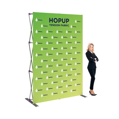 Trade show tension fabric display with branded logo backdrop and professional presenter