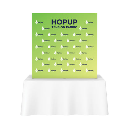 Hopup tension fabric backdrop with ReNew Energy branding displayed on a table for trade shows and exhibitions