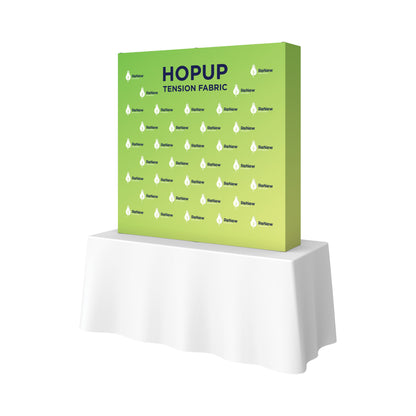 Pop-up tension fabric display on table for trade shows and exhibitions