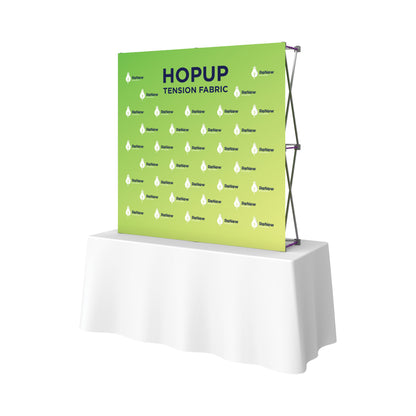 Trade show backdrop with tension fabric display on table for exhibitions and special events