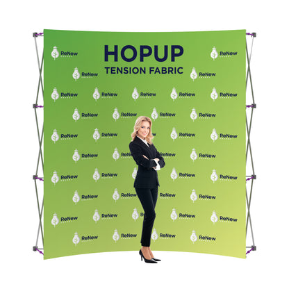 Trade show fabric backdrop display with ReNew Energy branding and businesswoman model in front