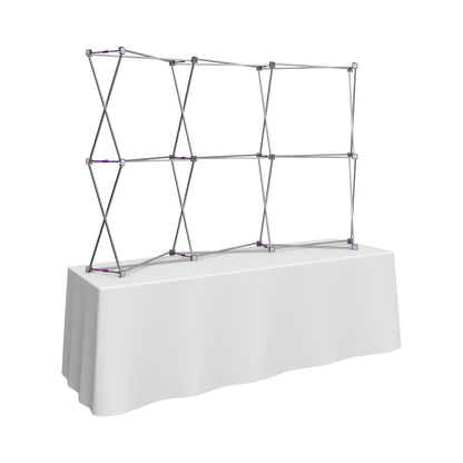Pop-up display stand frame on a table used for trade shows and exhibition booth setups