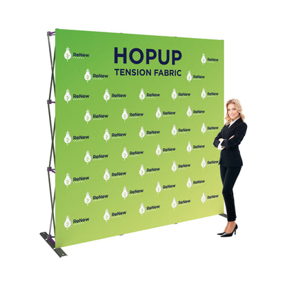Trade show tension fabric display with branded graphics and professional woman posing
