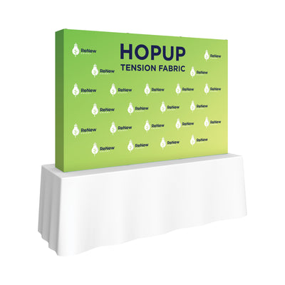 Trade show tension fabric backdrop with ReNew Energy branding displayed on a table