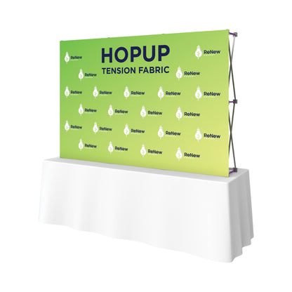 Pop-up tension fabric display on table for trade shows and exhibitions featuring Renew Energy branding
