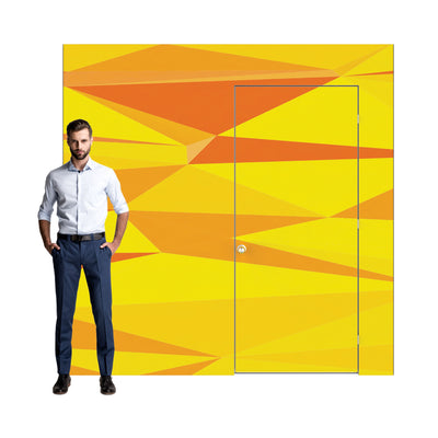 Man standing next to modular display wall with door featuring geometric patterns for trade shows