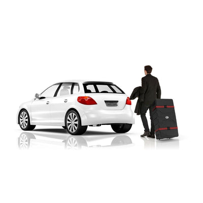 Man pulling large wheeled case for trade shows and exhibitions next to a compact car