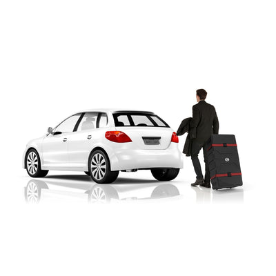 Man in suit pulling wheeled trade show display case near car, ideal for exhibitions and events