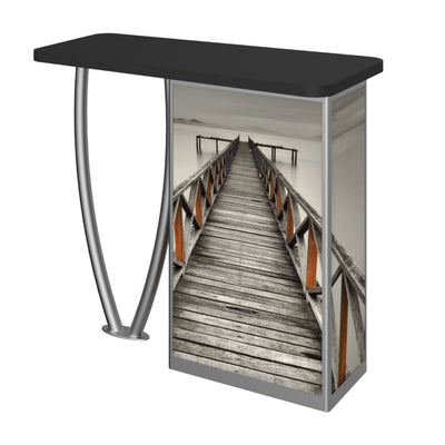 Trade show counter with durable graphic panel featuring a wooden pier extending into water for exhibitions and events
